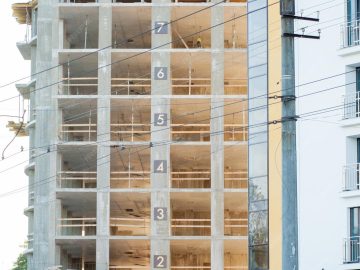 modern-building-construction-detail-concrete-frame-indow-openings-scaffolding_130265-12821